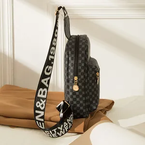 Black crocodile pattern crossbody bag with round geometric print and wide strap