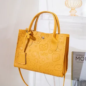 Bright yellow embossed PU leather tote bag with cartoon patterns and long strap