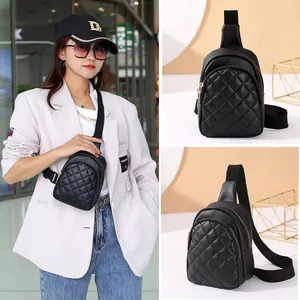 Black quilted mini chest bag with adjustable strap and dual zipper pockets for women