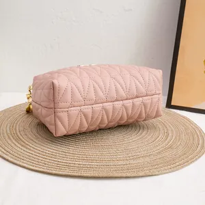 Pink quilted leather crossbody bag for women with golden chain and triangular embroidery