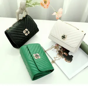 Three elegant quilted crossbody bags in black, white, and green with clover twist locks