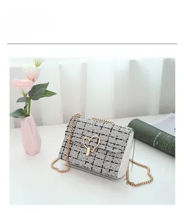Detail showing the 18cm wide heart-lock tweed chain bag with dimensions and texture