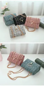 Close-up of elegant tweed crossbody bags featuring gold heart buckles and chain straps