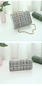 Detail of checkered canvas crossbody bag with heart lock and gold metal chain