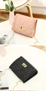 Detailed close-up of geometric triangle quilted stitching and gold twist lock on purses