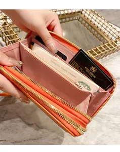 Detailed interior of long orange leather wallet with multiple card slots and coin pocket