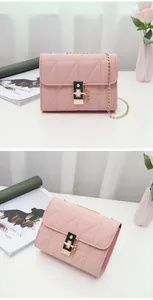 Close-up of pink quilted crossbody bag featuring a golden twist lock and chain strap