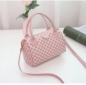Detail of light pink pillow bag featuring circular prints and a white 3D butterfly charm