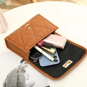 Quilted brown shoulder bag with gold clasp showing internal storage for essentials