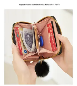 Detailed interior of woven coin purse with pink card slots and plush ball charm