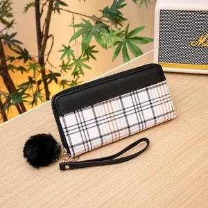Long zip-around wallet featuring black PU leather and classic tricolor plaid with pompom charm