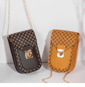 Detail of vintage patterned small crossbody bags with gold chains in brown and yellow