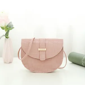 Pink stone pattern mini crossbody saddle bag with crocodile texture and gold clasp