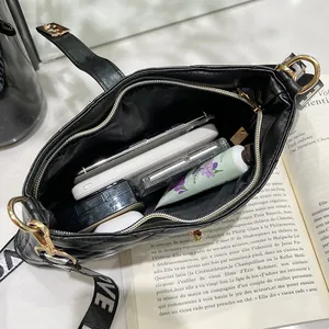 Borsa a tracolla trapuntata nera con tracolla larga e interno spazioso per l'uso
