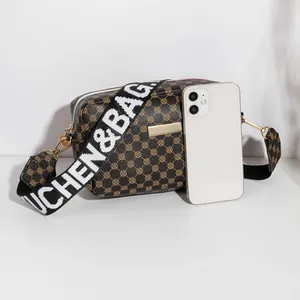 Sac bandoulière marron avec motif trèfle rétro et large bandoulière élégante