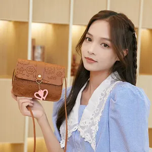 Brown PU crossbody small square bag with embossed cartoon patterns and heart pendant