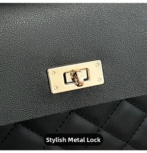 Macro detail of high-quality golden hardware lock and quilted leather on black bucket bag