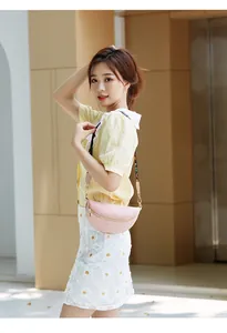 Detail of pink quilted waist bag featuring a stylish wide strap with colorful LOVE letters