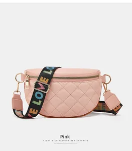 Detailed view of pink quilted waist bag with colorful LOVE embroidered strap and gold zippers