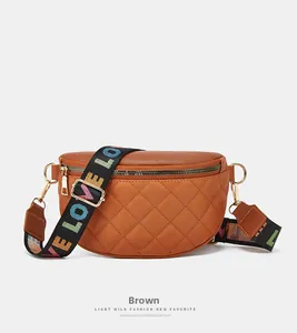 Detail of brown quilted waist bag with gold hardware and colorful LOVE webbing strap