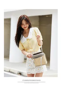 Close-up of woven straw handbag texture paired with floral skirt and yellow shirt