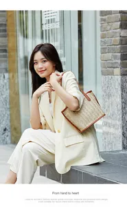 Detail of woven tote bag with brown leather trim and large capacity for summer