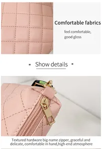 Close-up of pink quilted crossbody bag with golden hardware and colorful strap detail