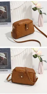 Detailed macro view of brown quilted crossbody bag with Y-pattern stitching and gold hardware