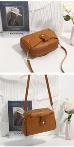 Detailed macro view of caramel brown quilted crossbody bag with golden hardware hooks