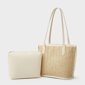 Women's large woven tote bag with matching leather clutch and dual shoulder straps