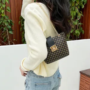 Women's brown monogram bucket bag with gold chain strap and square lock closure