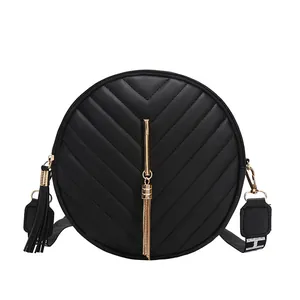 Classic black round crossbody bag with V-quilted pattern and golden chain tassel detail