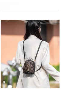Outdoor model show of a mini retro backpack with pearl cat ring and geometric pattern