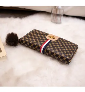Brown faux leather long wallet featuring a metallic bee icon and striped ribbon detail