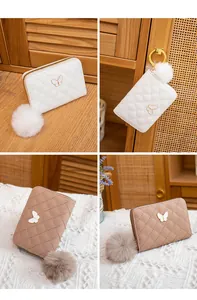 Detail of quilted leather mini wallets with butterfly charms and faux fur pompom accents