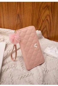 Pink quilted long wallet featuring butterfly buckle, wrist strap and plush ball charm