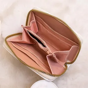 Mini white leather accordion wallet with pink lining and multiple card slots