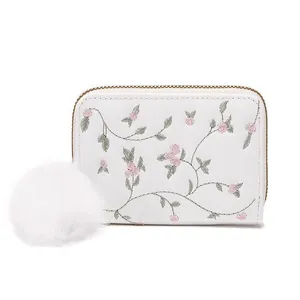 White PU leather small coin purse with floral embroidery and fluffy white pom-pom charm