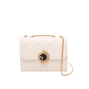 Sac bandoulière crème chic avec matelassage étoiles et fermoir céleste doré