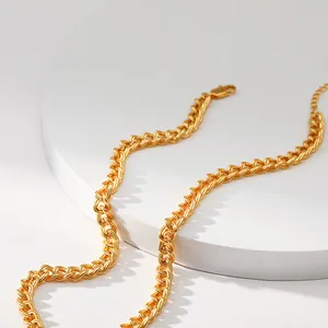 Nahaufnahme der goldenen Metallkette mit Webstruktur, Karabinerverschluss und Verlängerung
