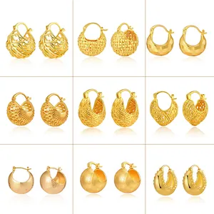 Collection of nine gold hollow ball earrings with woven textures and geometric metal designs