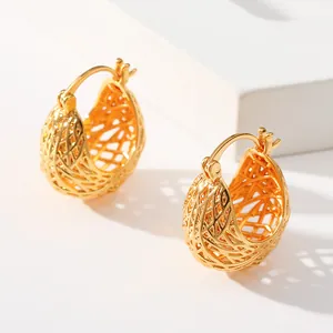Detailed close-up of woven mesh hollow ball hoop earrings in polished 18K gold finish