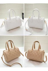 Detail of quilted diamond pattern on mini cylinder pillows bags in white and beige PU leather