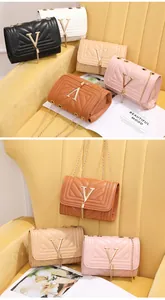 Detail view of five quilted crossbody bags with V-shaped metal logos and tassels