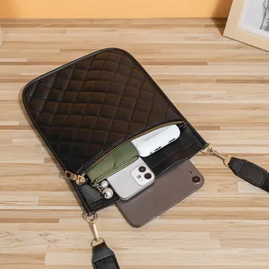 Black quilted cross-body phone bag with golden zippers and multi-compartment storage