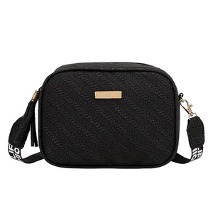 Black woven crossbody bag with golden plaque, fringe detail and wide LIFE strap