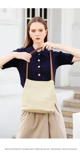 Close-up of woven bucket bag with contrast leather handles and textured wave patterns