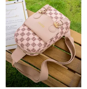 Détail du sac de poitrine rose à carreaux avec boucle dorée sur table en bois