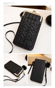 Detail of black quilted leather phone bag with gold metal frame and kiss-lock closure