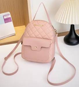 Detailed close-up of pink quilted mini backpack with gold logo and magnetic front pocket